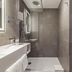 Novotel Düsseldorf Airport bathroom with walk-in shower, sink, and wall-mounted toilet in Düsseldorf