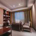 Taizhou Chunlan Hotel in Taizhou study-style suite with desk, chairs, sofa, bookshelves and window view