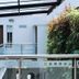 Hotel DC Feria in Bogotá: modern interior walkway with glass railing and indoor greenery wall