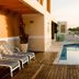 Mont Blanc Apart Hotel - Duque de Caxias rooftop pool with lounge chairs and palm view in Rio de Janeiro