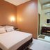 Patria Garden Hotel Blitar room with bed, desk and wall-mounted air conditioner
