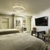 The Edward Buffalo in Buffalo guest room with two beds, wall-mounted TV, desk and closet
