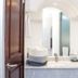 Hotel Boutique Plaza Doradas bathroom with arched ceiling, marble sink, and shower in San José del Cabo