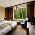 Hakodate-Onuma Prince Hotel room in Nanae with two beds and large window overlooking trees