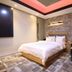 Daegu Innovalley hotel room in Daegu with king bed, stone accent wall, and seating bench