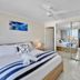 Royal Palm Resort in Palm Beach guest room with bed, mirrored closet and ocean-view balcony