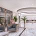 The Prestige Hotel Penang lobby in George Town with curved ceiling, marble floors, and pastel lounge chairs