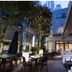 Hotel Rose Garden Shinjuku in Tokyo, outdoor courtyard dining area with trees and evening lighting