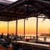Tilghman Island Inn waterfront patio with sunset view, string lights, and outdoor seating