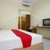 RedDoorz @ Seturan Raya 2 in Depok guest room with bed, desk, TV, and wardrobe