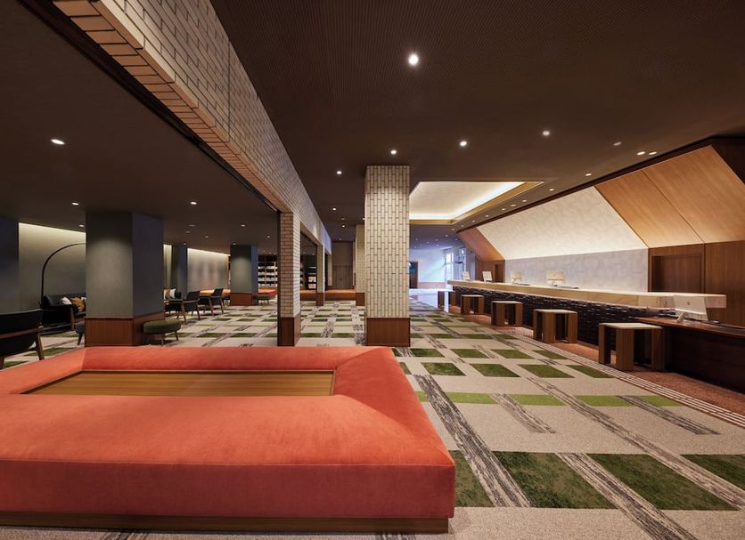 Kamenoi Hotel Aso Park Resort in Aso lounge with red seating, patterned carpet, and bar area