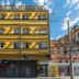 Minuano Hotel Home in Porto Alegre, yellow facade with balconies and street view