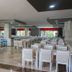 Serra Park in Side: spacious hotel dining room with rows of white chairs and tables