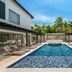 Royalton CHIC Punta Cana pool between modern resort buildings with loungers and palm trees in Punta Cana