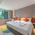 Home2 Suites by Hilton Xishuangbanna Jinghong room with king bed, window view and colorful rug