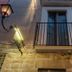 Domatia in Barletta, 3-star hotel facade with lit wall lantern and small wrought-iron balcony