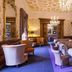 Mercure Aberdeen Ardoe House lounge in Aberdeen with chandeliers, sofas, fireplace and patterned wallpaper