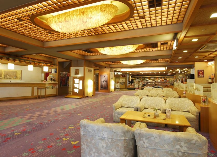 Tosagyoen hotel lobby in Kochi with ornate ceiling lights, seating area, and reception desk