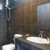 Phangan Great Bay Resort bathroom in Ko Pha Ngan with tiled shower, toilet, and sink