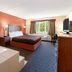 AmericInn by Wyndham Silver City room with whirlpool tub, king bed, and window view