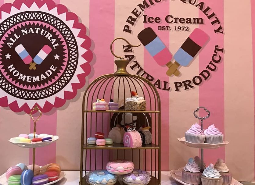 Fantasy Hotel Malacca image of a pink dessert display with cupcakes, macarons and ice cream signage