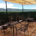 Hotel Temático Mision Colonial terrace with shaded outdoor tables and mountain views in San Cristóbal de las Casas