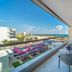 Planet Hollywood Adult Scene Cancun balcony with ocean view, glass railing and outdoor seating in Cancún
