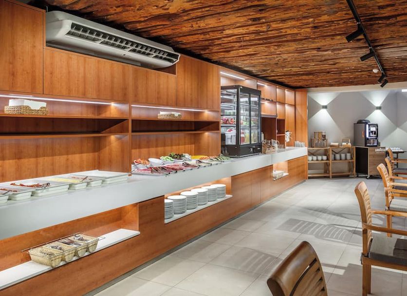 Playa Surf Cbbc Hotel in El Médano lobby breakfast buffet with wood-paneled ceiling and seating