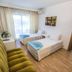 Serra Park in Side hotel room with two single beds, sofa, balcony door and adjoining room