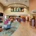 Comfort Suites Texarkana lobby with seating area, front desk, and dining space