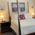 Terrell House B&B in Burnsville bedroom with four-poster bed, bedside lamps, and window curtains
