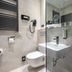 Michel Hotel Waldkirchen am Badepark bathroom with walk-in shower, wall-hung toilet and sink in Waldkirchen