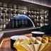 Yiting Huicheng Hotel Xiamen lounge with illuminated bookshelf wall and decorative ocean mural