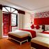 La Beaute De Hanoi Hotel in Hanoi: red-and-white twin guest room with patterned headboard and balcony doors