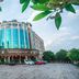 Wuyue Yuexin Hotel (Jinggangshan) in Ji'an exterior with curved glass facade and parking area