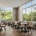 Residence Inn By Marriott New York Jfk Airport dining area with floor-to-ceiling windows and tree views in Queens