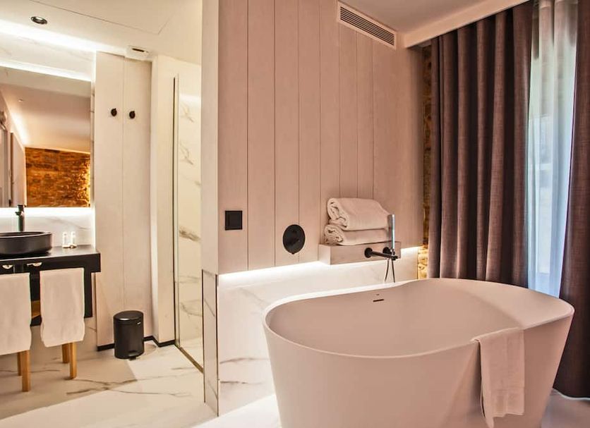 Hotel Plaza Obradoiro by Bossh! Hotels bathroom with freestanding tub, double sink vanity and shower in Santiago de Compostela