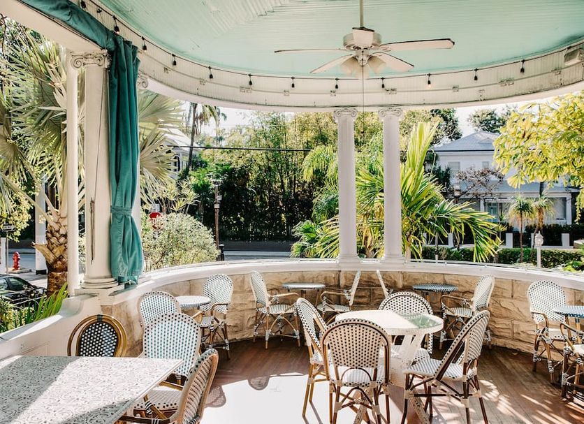 Classic King- Curry Mansion with Heated Pool! in Key West, open-air patio with tables and tropical garden views