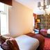 Loch Kinord Hotel, Aboyne: twin room with two single beds, patterned wallpaper and chandelier
