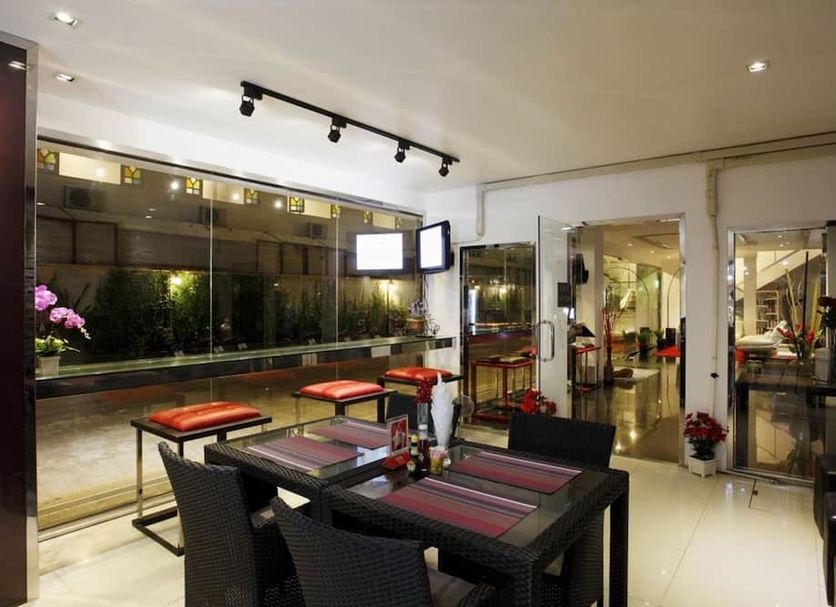 Grand Sunset Hotel Phuket in Karon: indoor dining area with tables, chairs, and view into lobby