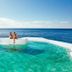 Albatroz Beach & Yacht Club in Santa Cruz: oceanfront pool deck with two guests beside the sea