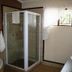 Oak Rest Guesthouse Kimberley bathroom with glass shower, bathtub and window with sheer curtains