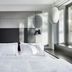 citizenM Rome Isola Tiberina guest room with bed beside large window in Rome