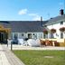 The Bluebird Inn at Samlesbury in Blackburn, exterior courtyard with lawn, seating and central walkway