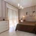 Hotel Residence Ulivi e Palme room in Cagliari with double bed, balcony doors and modern decor