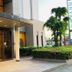 Sky Hotel Matsuyama entrance with glass doors, covered drop-off area, and landscaped greenery