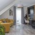 Lakeside Resort Michaela in Alsfeld, attic suite with sofa, desk, TV and large window