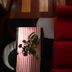 B&B Gildo Trani living area with red sofa, striped coffee table and dark patterned rug