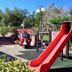 Hotel Belvedere in Caserta with a colorful playground featuring a red slide and small ride-on car