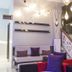 Le Noranda Hotel & Spa lobby seating area in Rouyn-Noranda with hanging lights and staircase